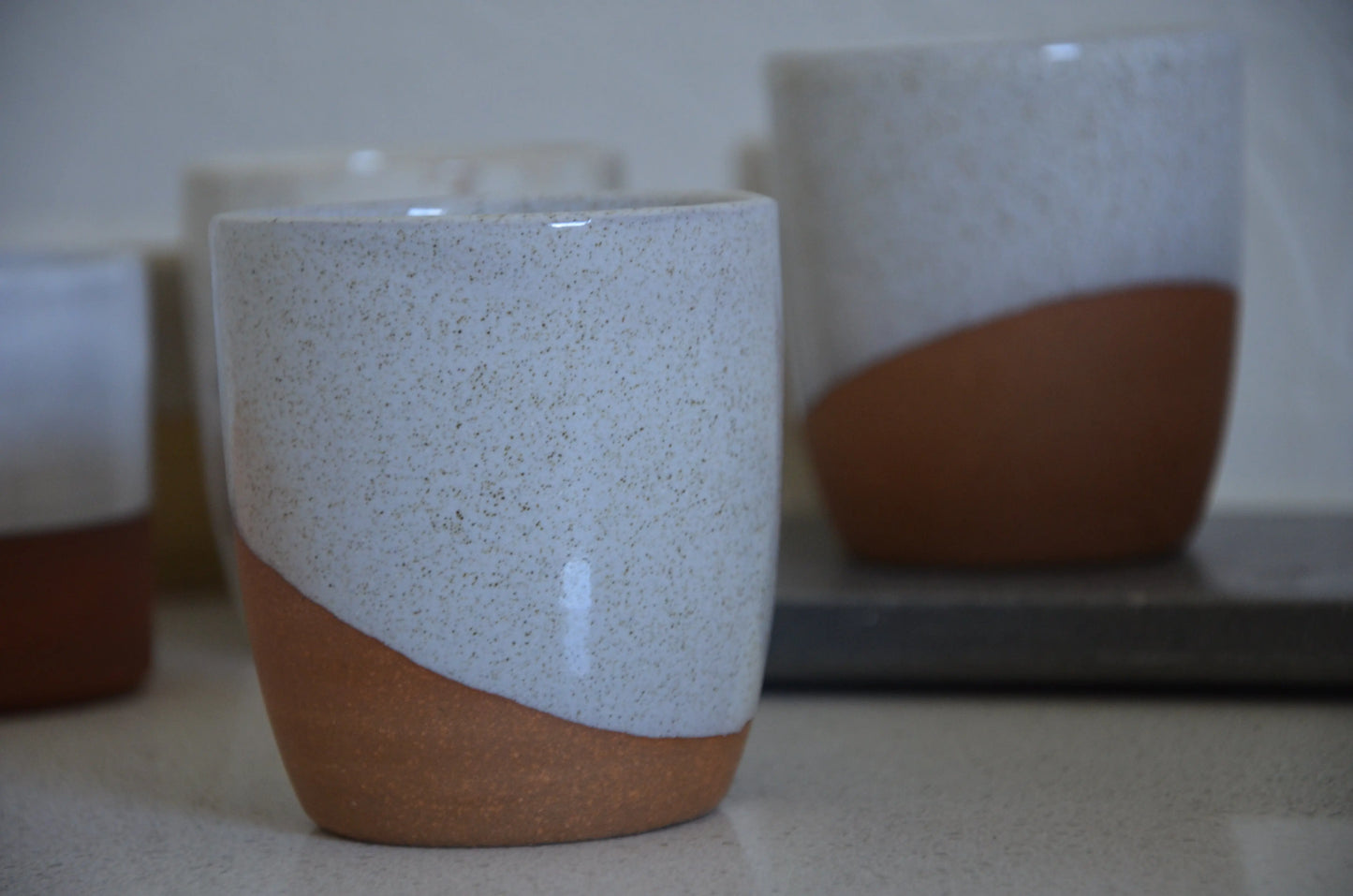 Hand Thrown Light Brown And White Glaze Travel Mud with Black Silicone Lid Bruce Wood Ceramics